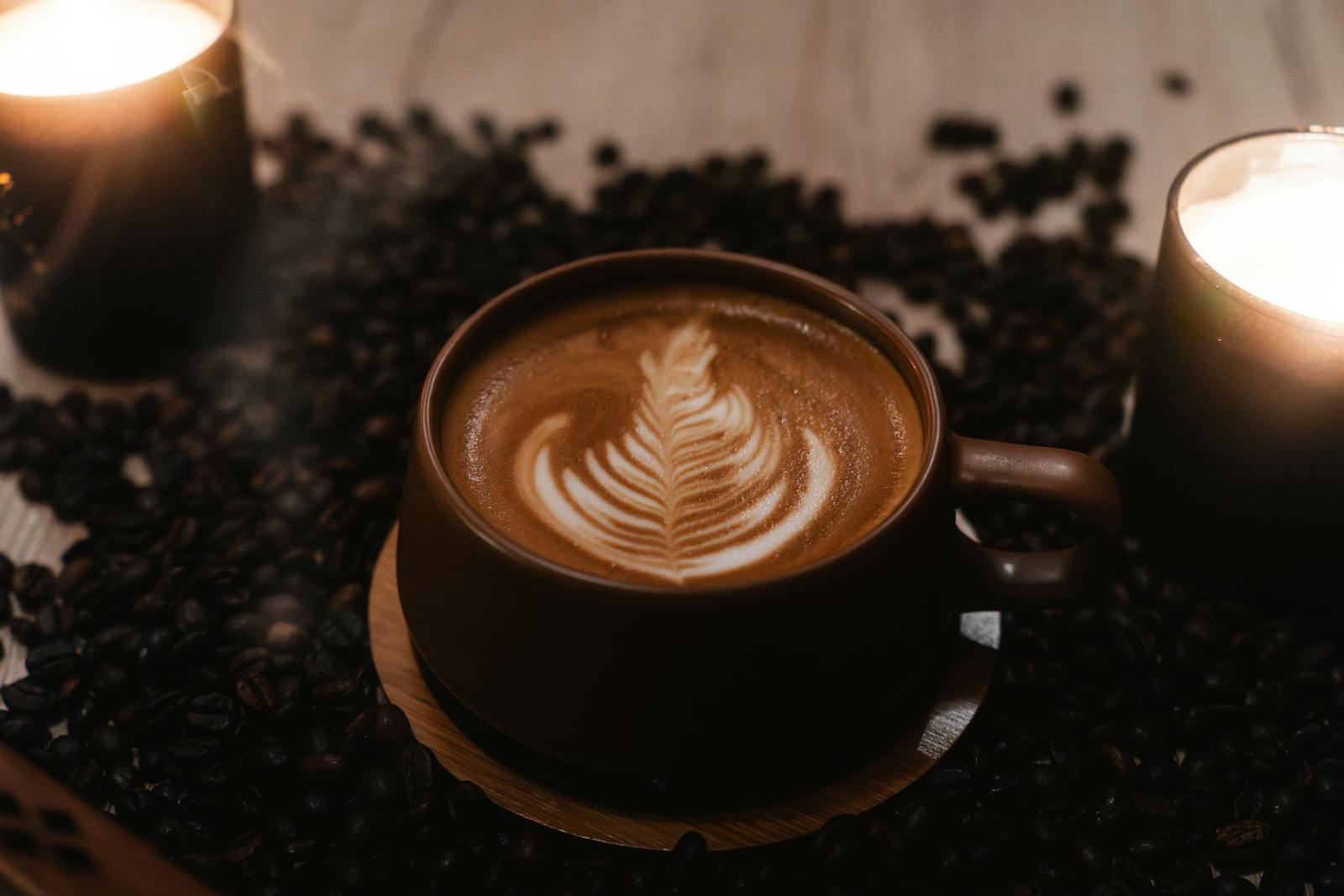 cozy cappuccino with latte art and candles