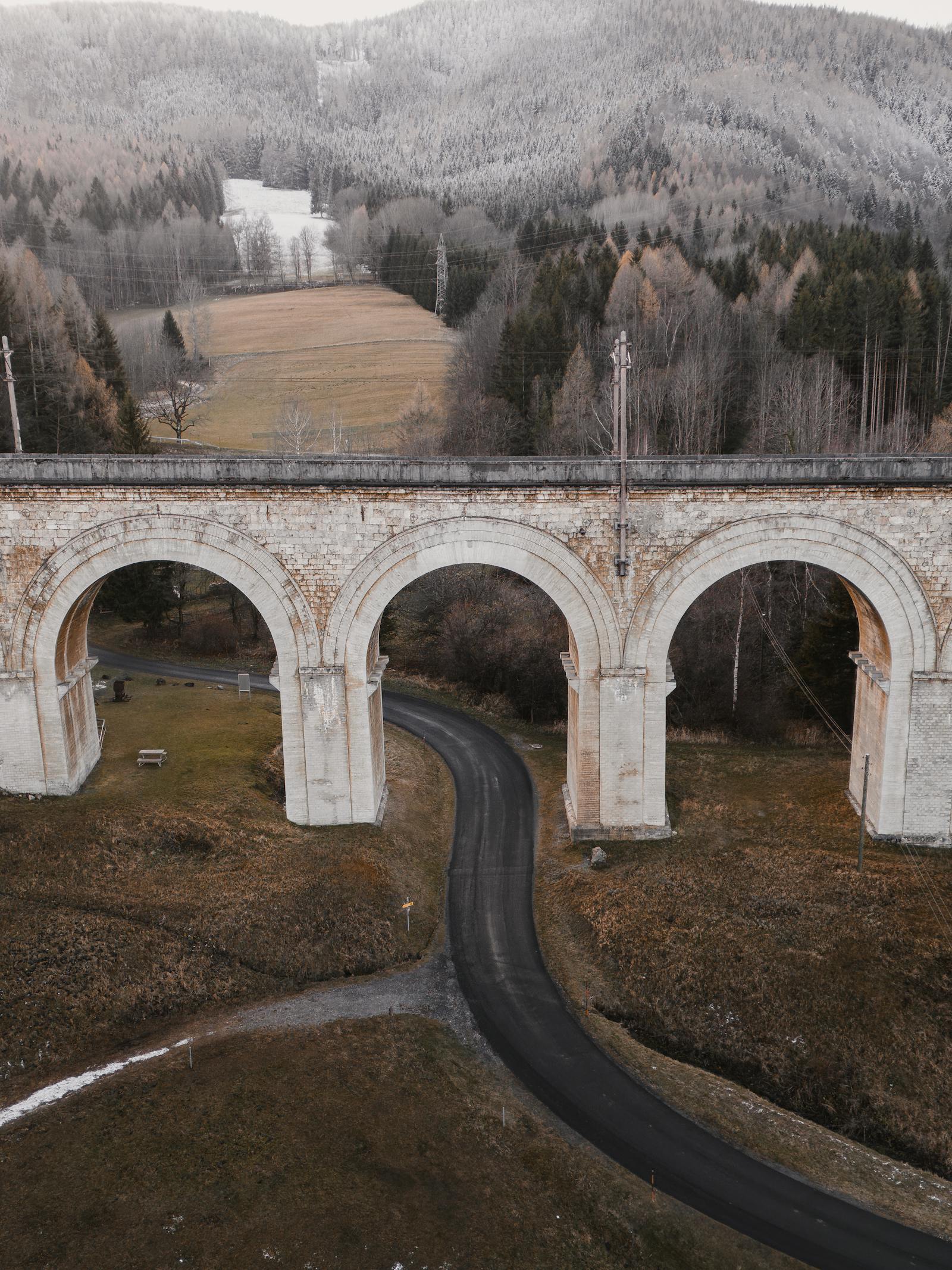 A stunning view of the historic Semmering Viaduct in a wintry Lower Austria landscape.