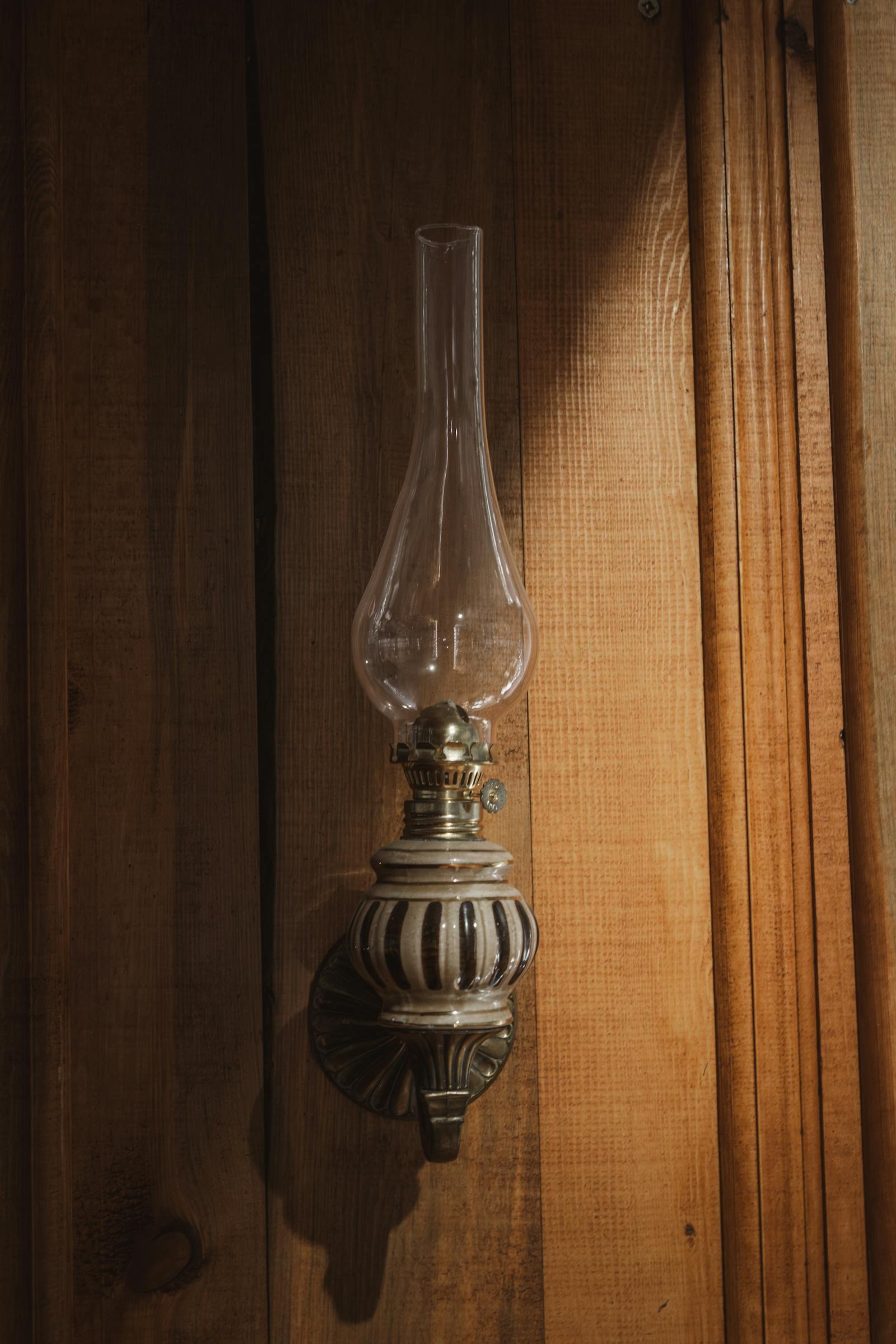 Antique wall-mounted glass lantern casting a cozy ambiance.