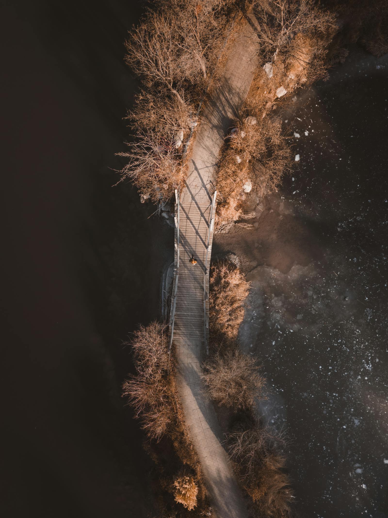 aerial view of bridge in winter landscape