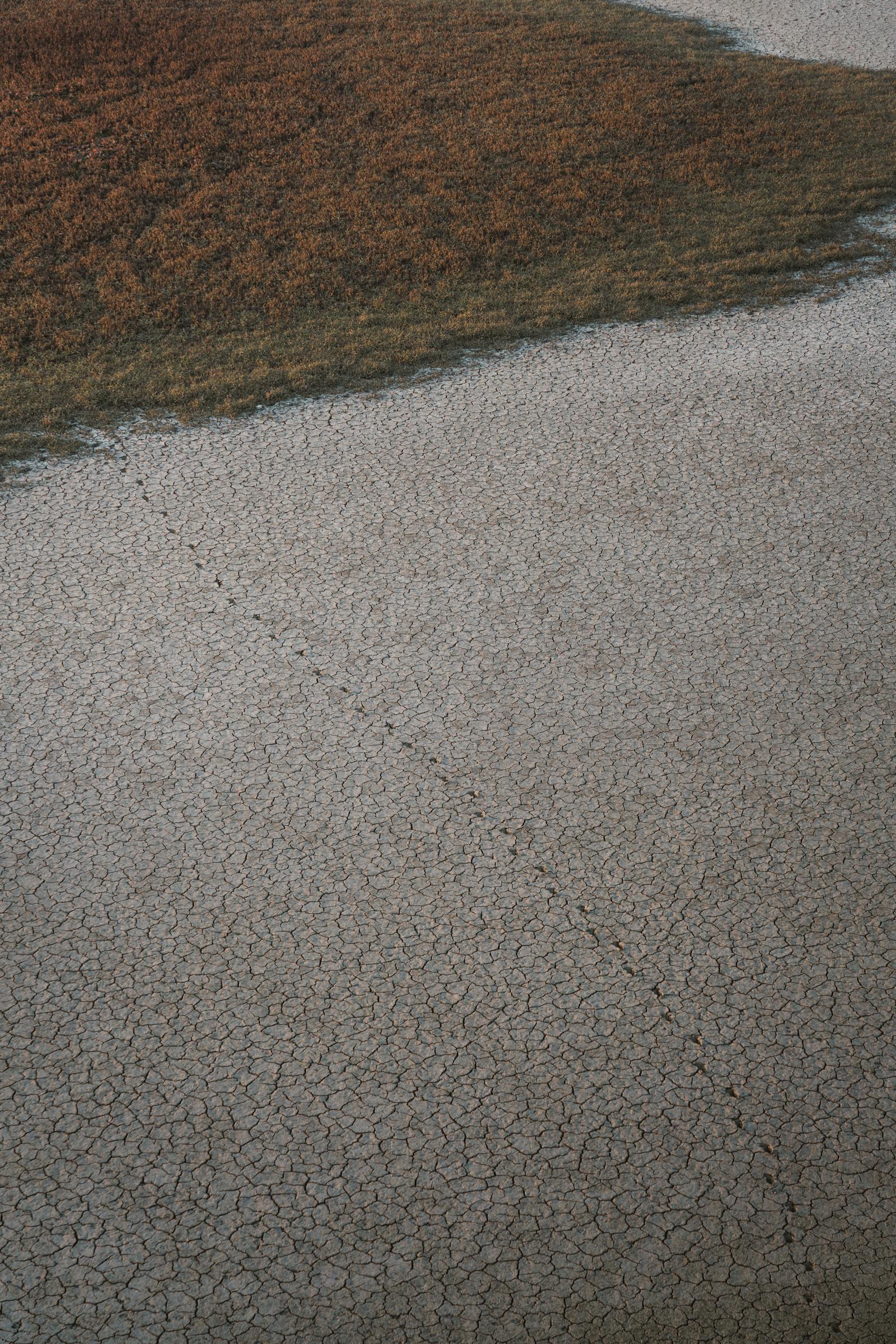 Aerial shot of a cracked earth landscape with a natural pathway in Nallıhan, Ankara, Türkiye.