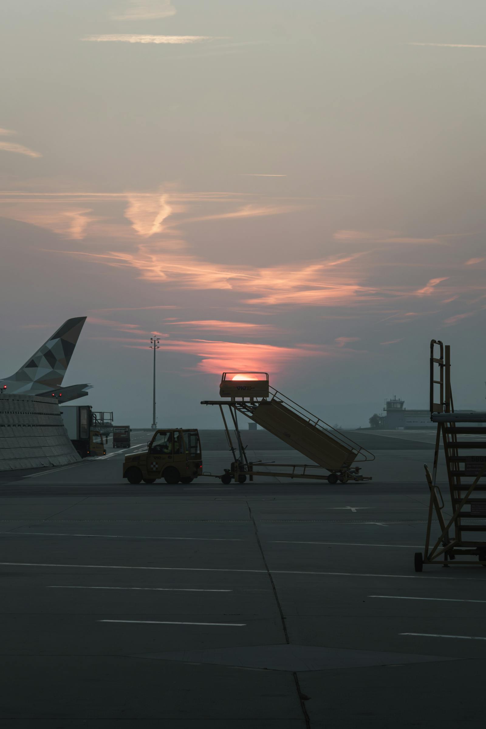 A serene sunset view at Schwechat Airport with silhouette elements.