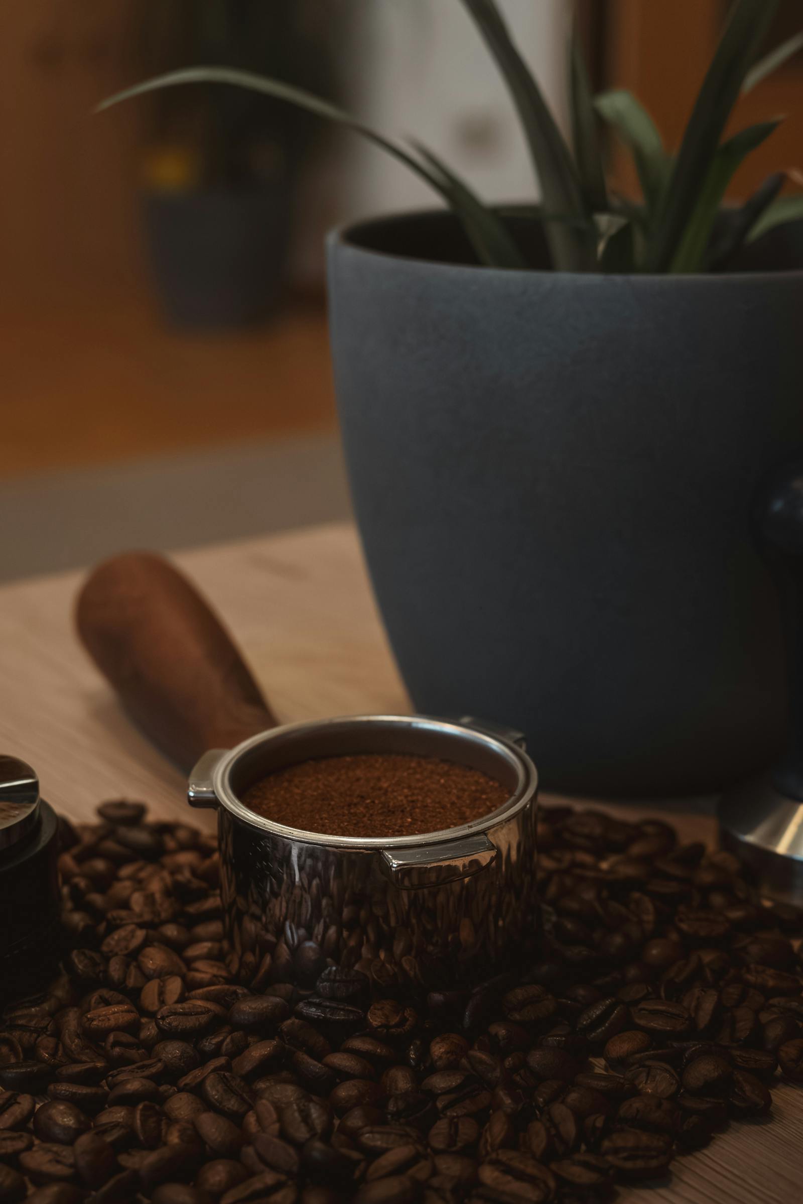 A grounded coffee portafilter surrounded by beans, highlighting artisanal brewing in Graz.