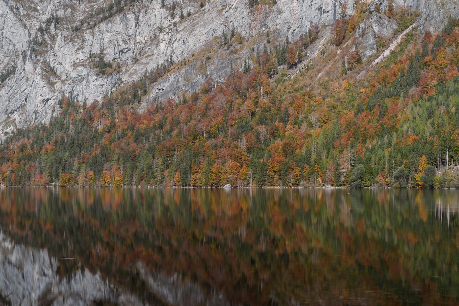 Tranquil mountain lake with autumn foliage reflections in the Austrian Alps, Eisenerz.