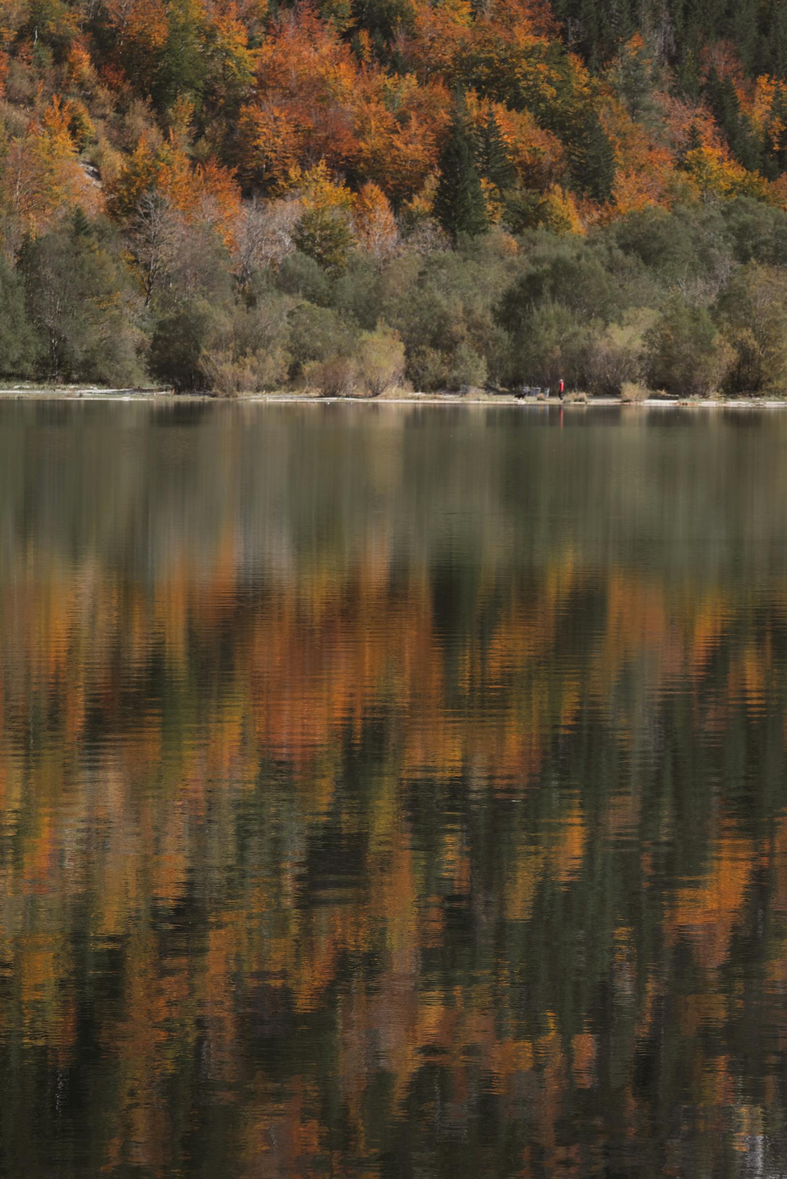 Scenic autumn reflections on a serene lake in Eisenerz, Styria.