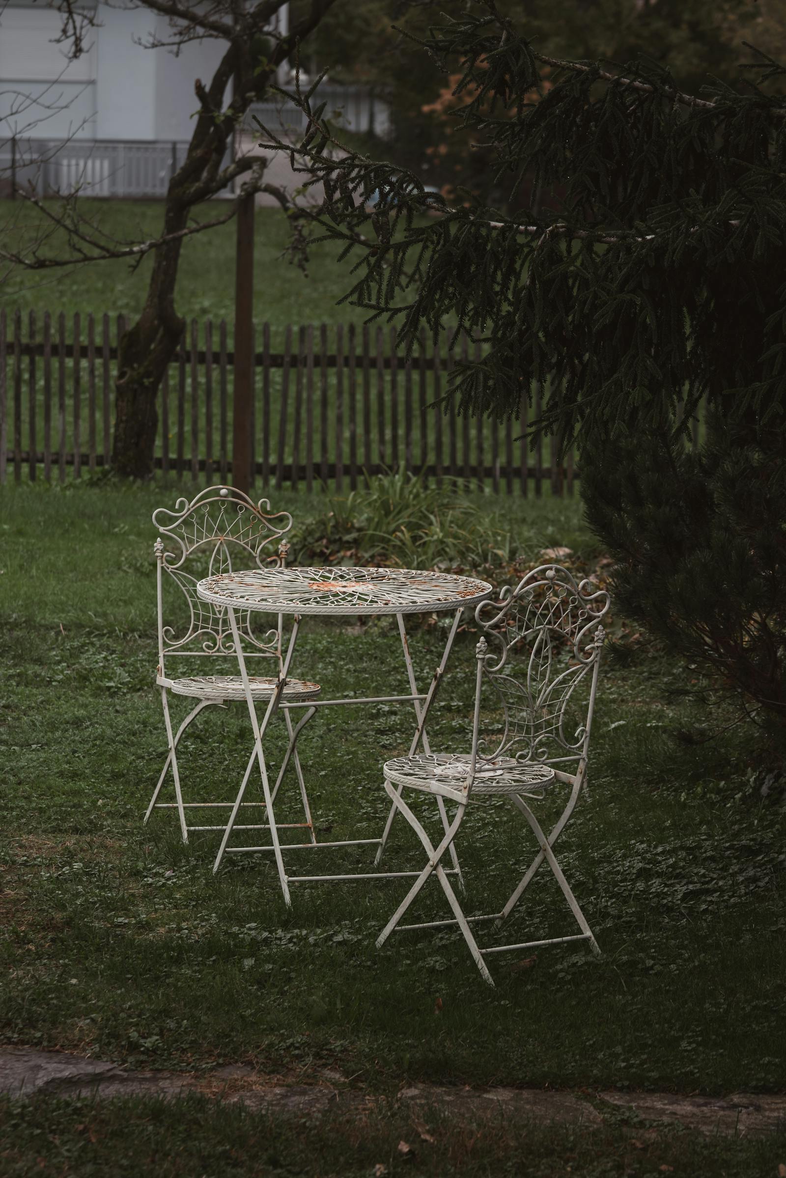 Peaceful outdoor garden setting featuring vintage iron furniture, perfect for tranquility and retreat.