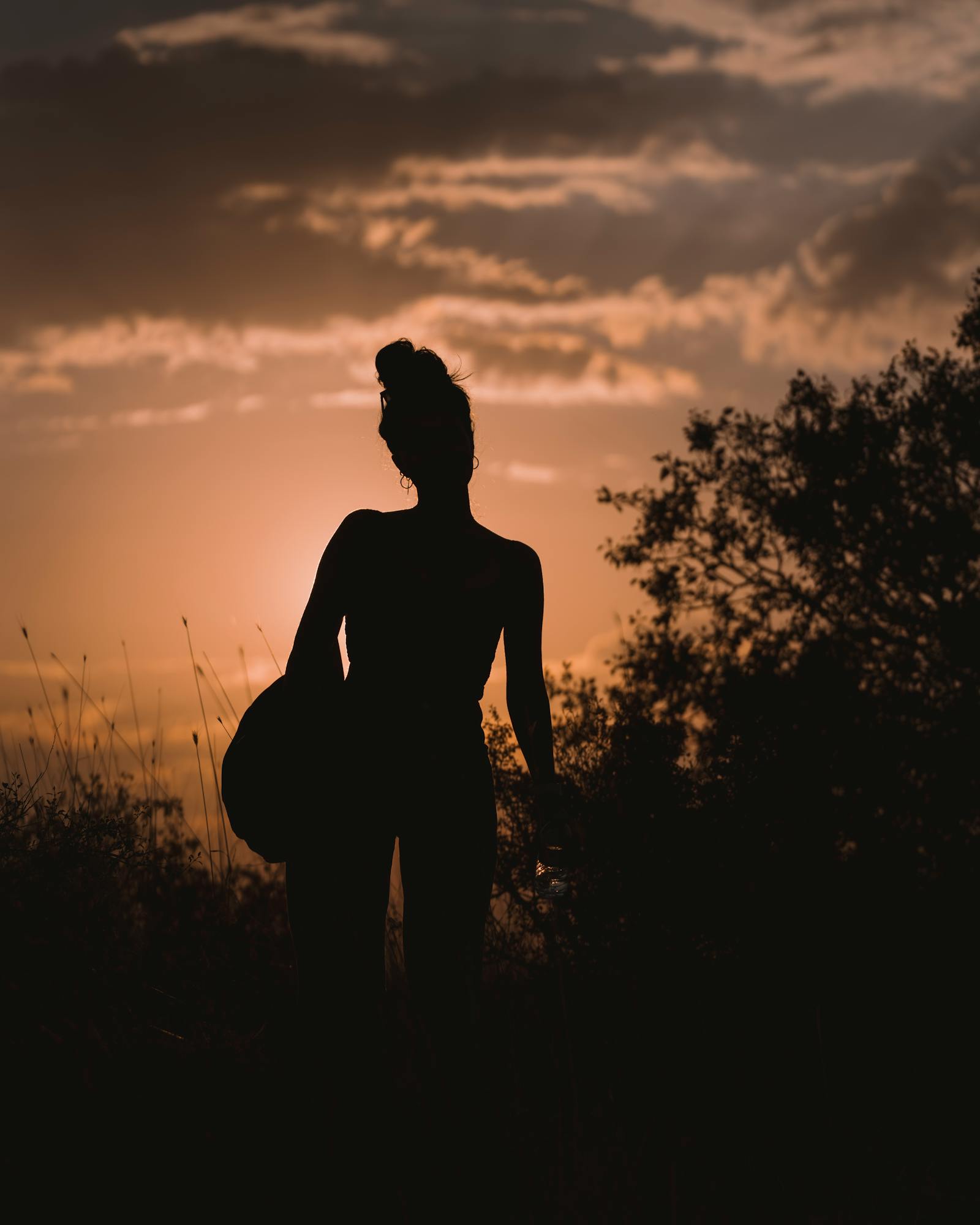 A silhouette of a person against a warm Ankara sunset, capturing the serene golden hour.