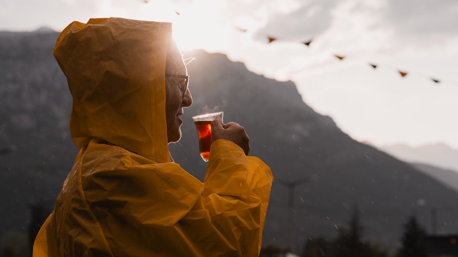 Enjoy a serene tea moment at golden hour in Seydişehir, Türkiye, with stunning mountain views.