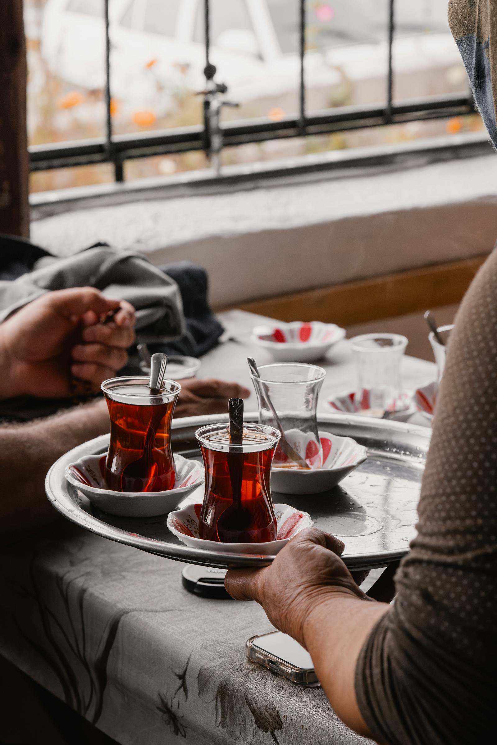 A warm, traditional Turkish tea serving scene captured indoors, showcasing cultural bonding.