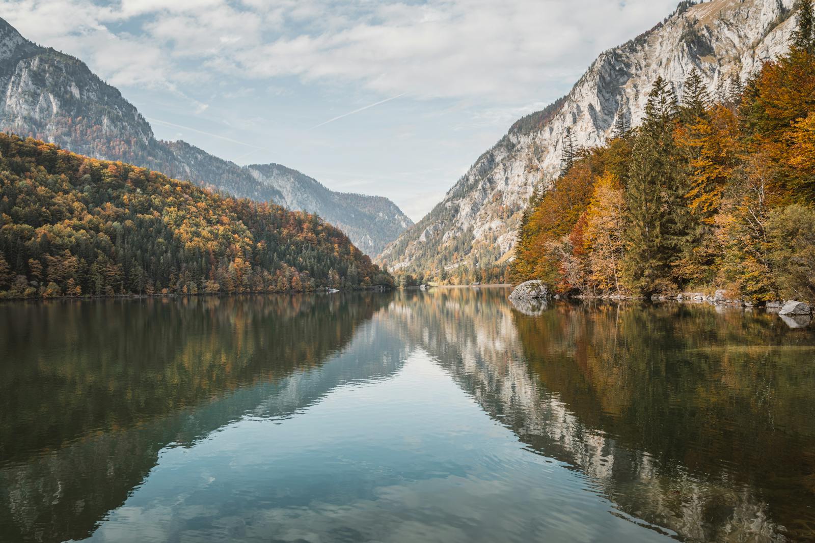 Serene autumn landscape reflecting on a lake in Graz, Styria, Austria.