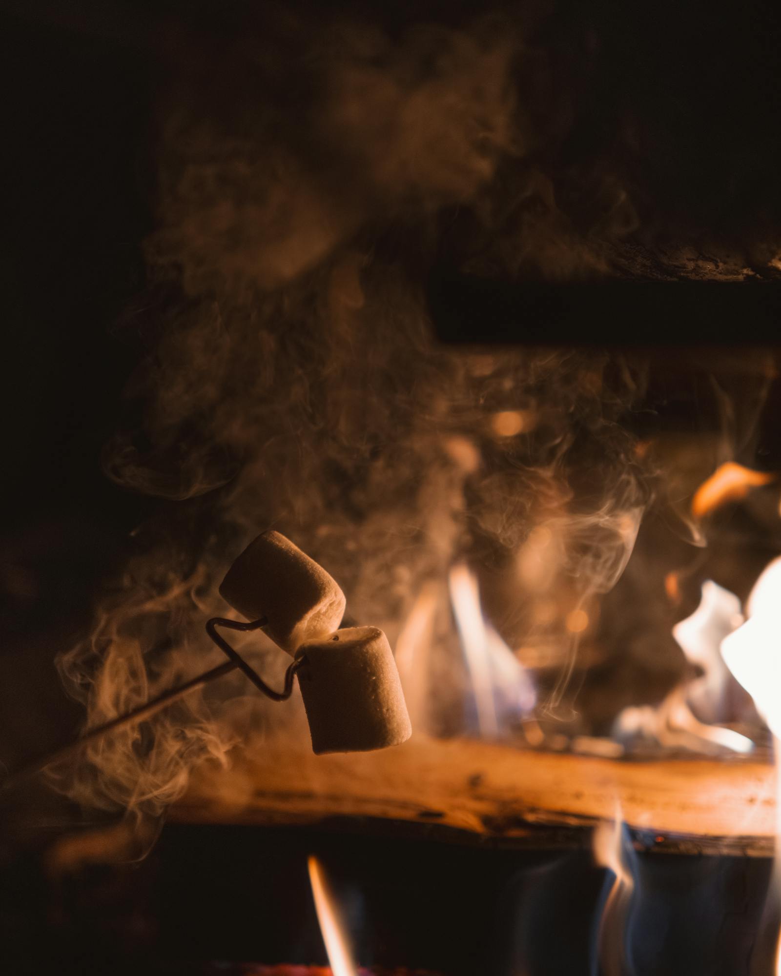 Warm campfire scene at night with marshmallows roasting in Rovaniemi, Finland.