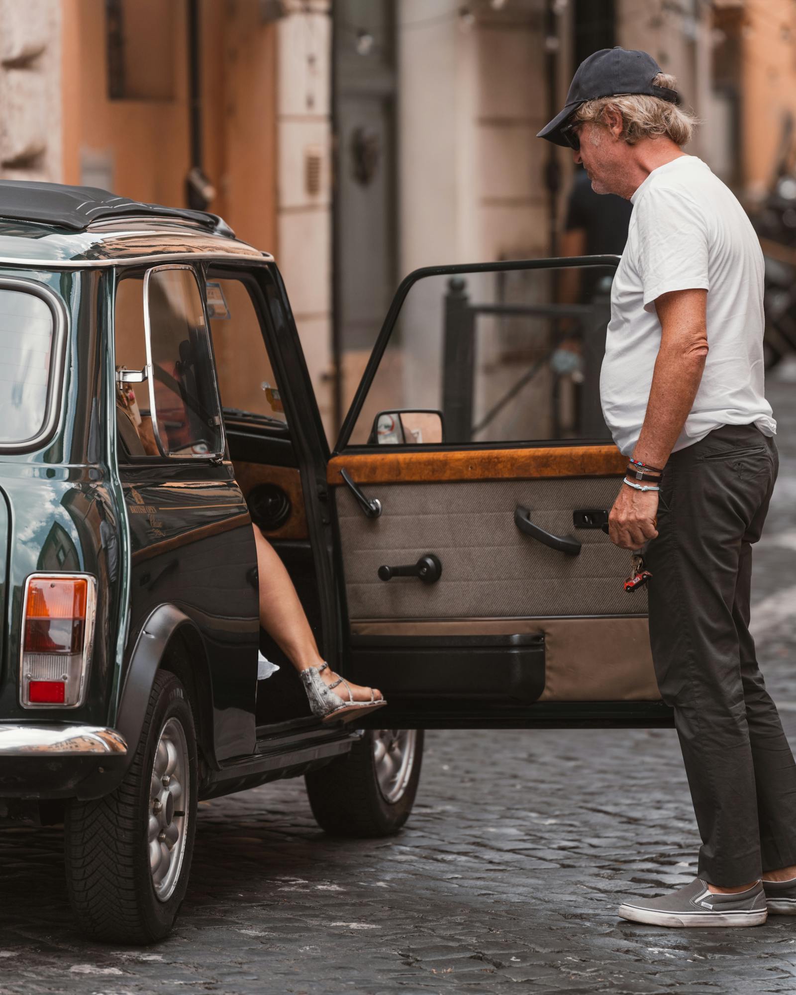 A classic car with passengers in Rome captures urban life and retro vibes.