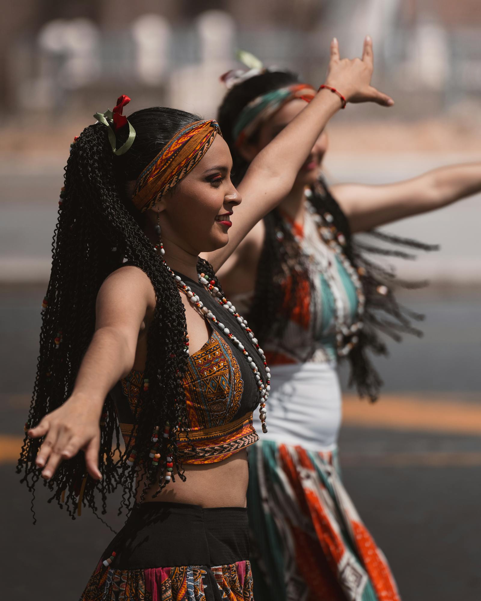 Joyful women in traditional attire performing lively cultural dance in sunny Rome.