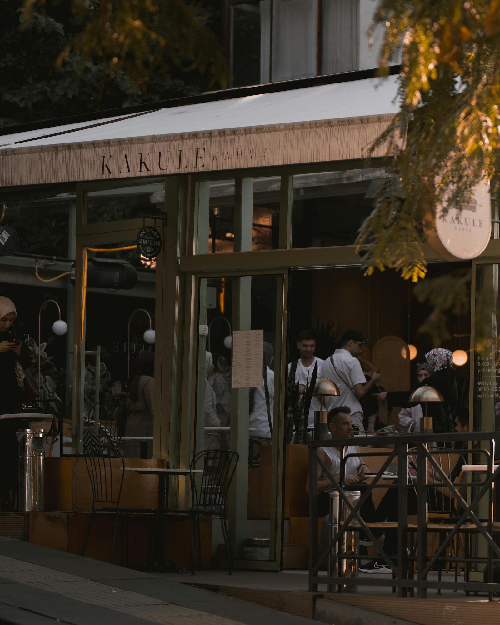 Cozy evening ambiance at a popular cafe in Ankara, Türkiye, bustling with life and warm lighting.