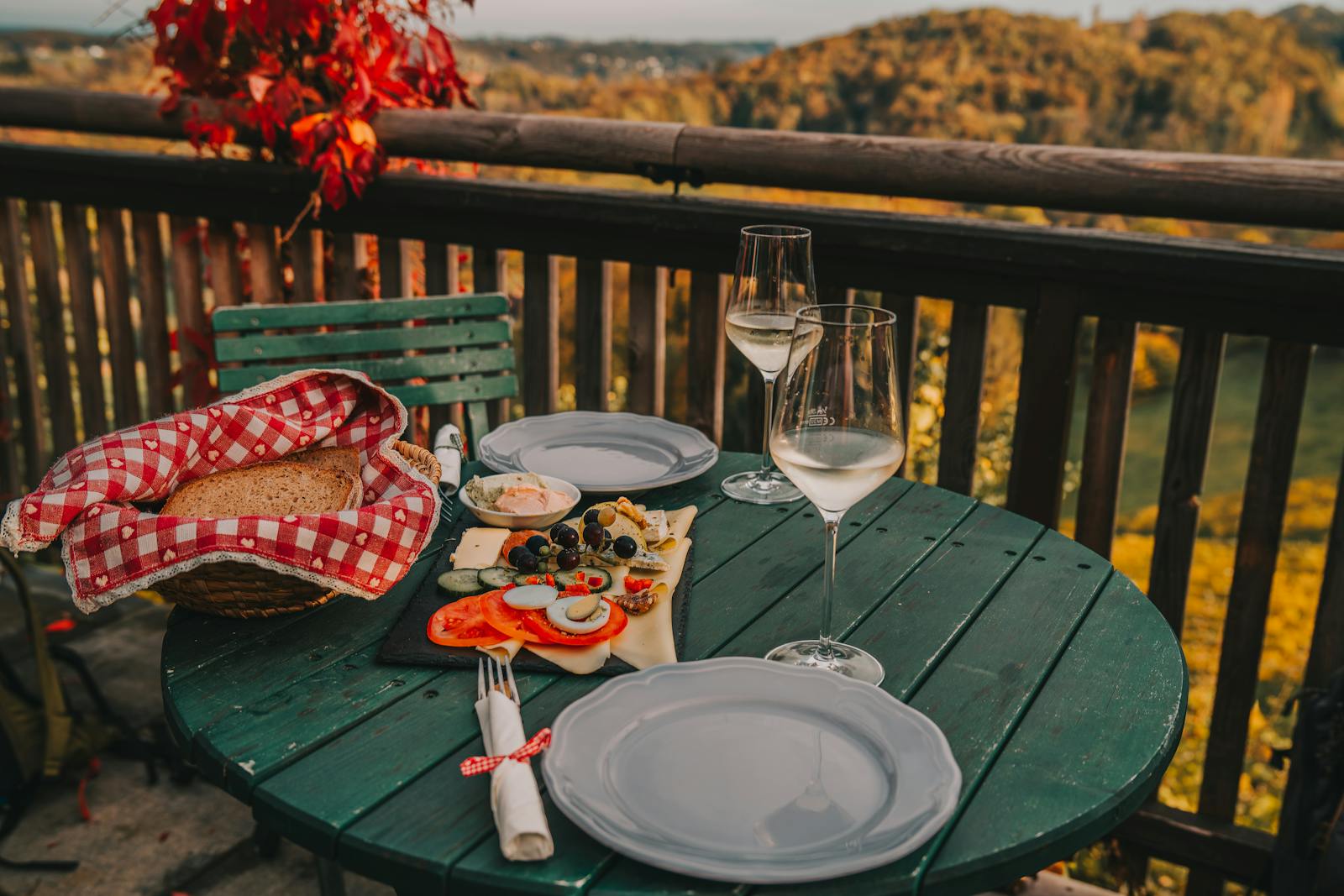 Cozy meal setting on a vineyard terrace with autumn views in Graz, Austria.