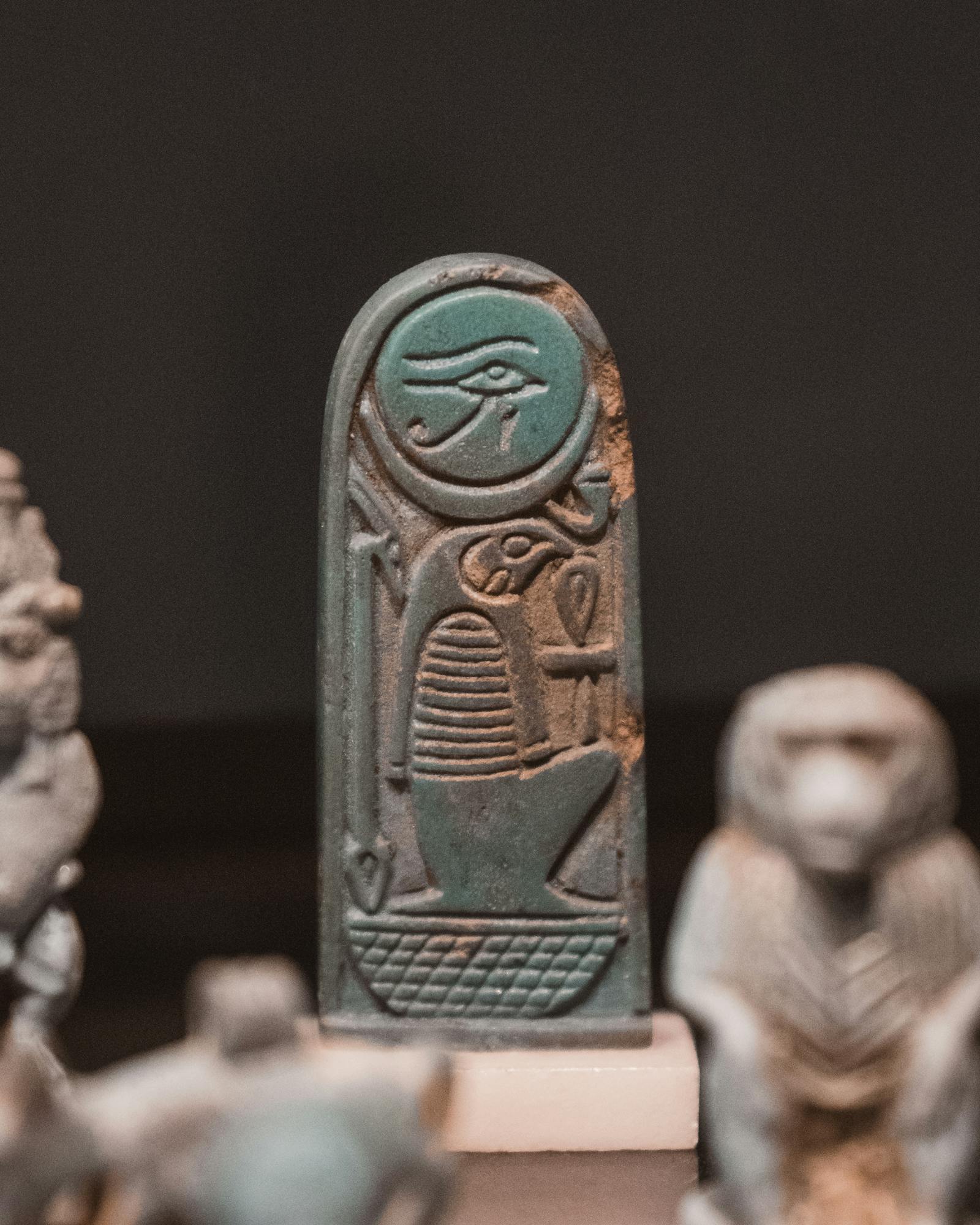 Turquoise ancient Egyptian artifact depicting Eye of Horus at the Louvre Museum.