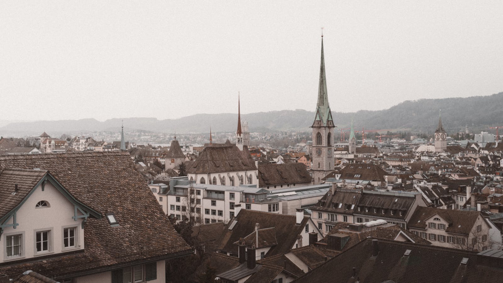 Aerial view of the picturesque old town of Zürich, highlighting historical architecture and iconic churches.