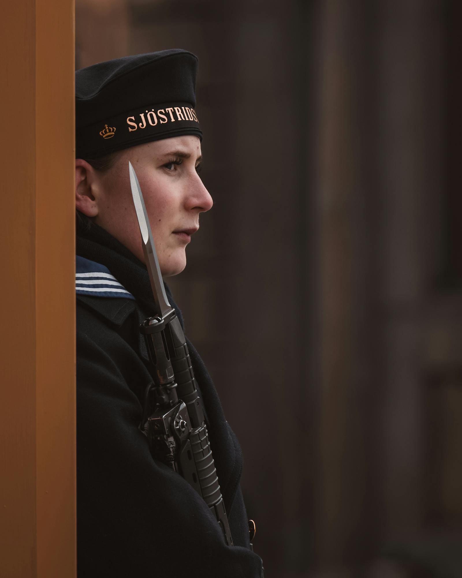 A Scandinavian soldier in uniform, standing guard with a rifle in Helsinki, Finland.