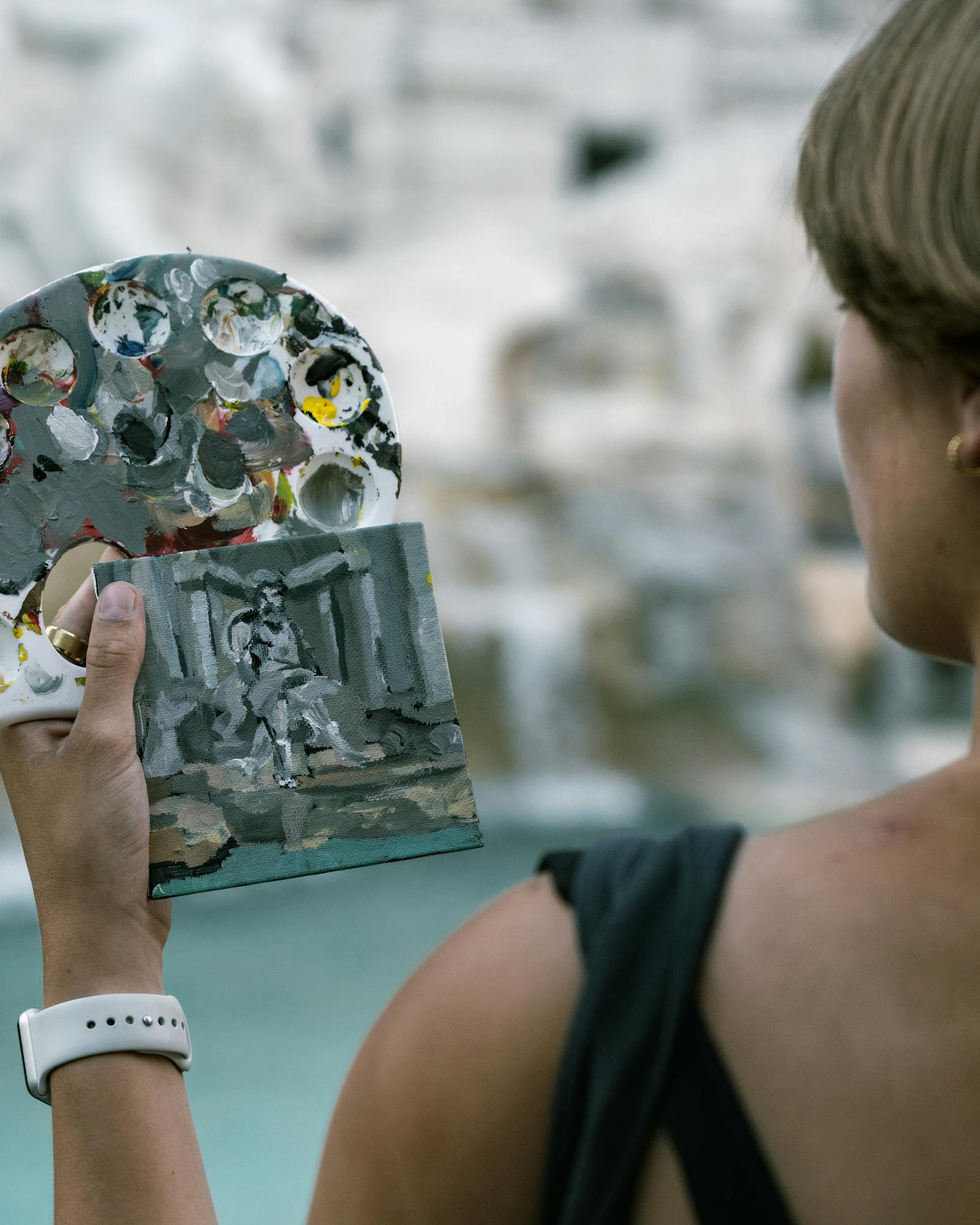 Woman artist painting the iconic Trevi Fountain in Rome, Italy.