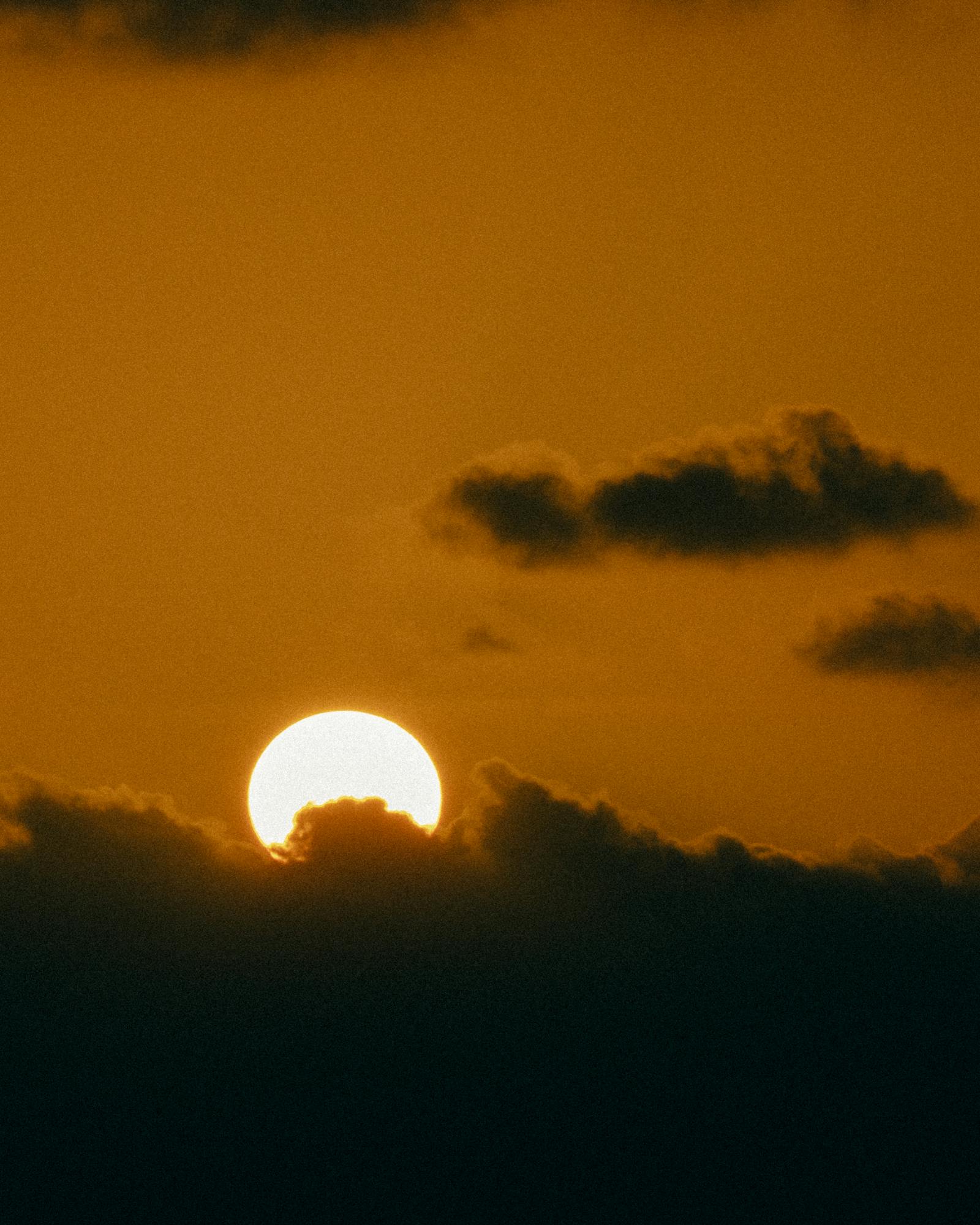 Serene sunset with dramatic clouds over Mellieħa, Malta.