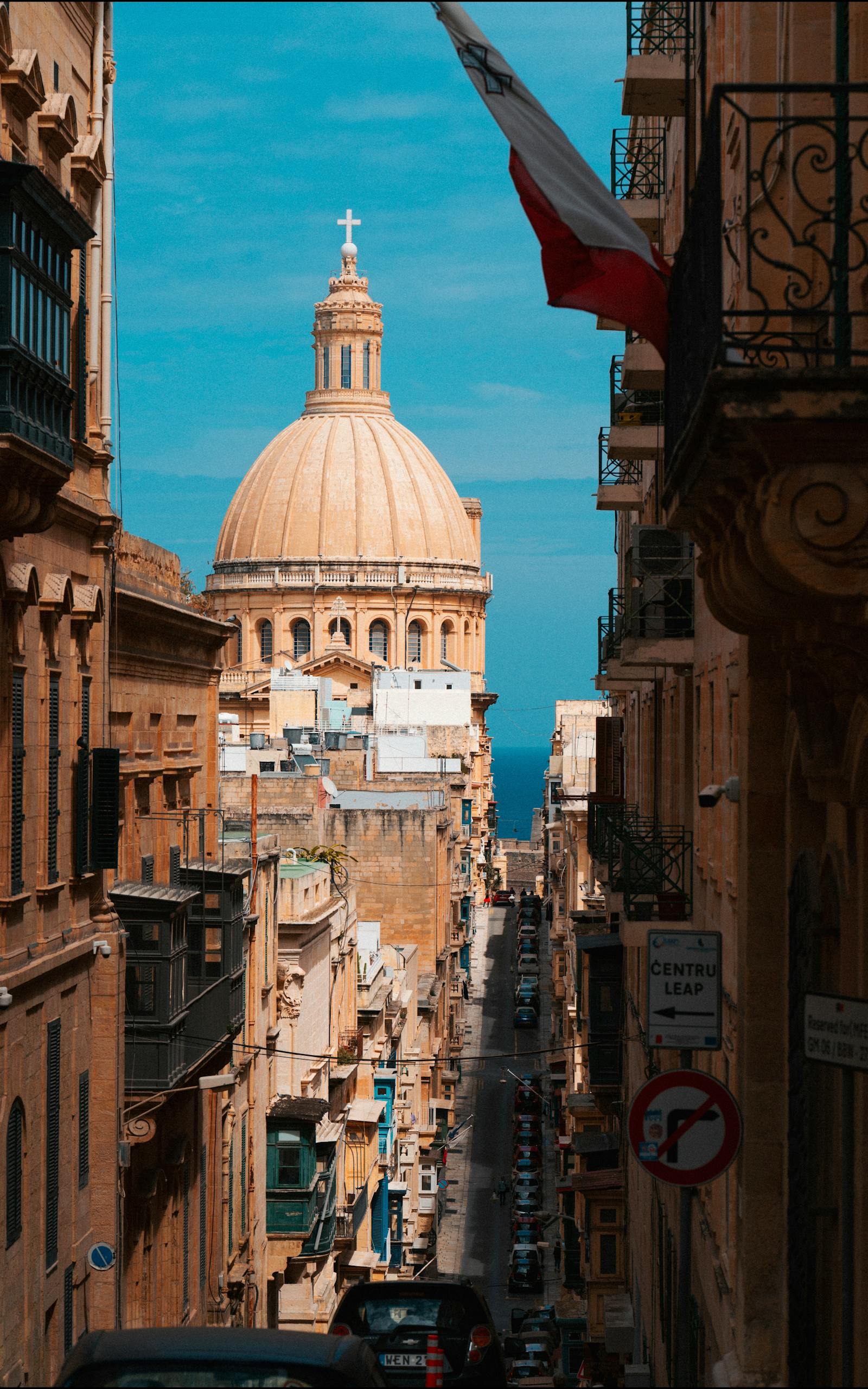 Capture the charm of Valetta, Malta with this view of historic streets leading to a grand cathedral dome.