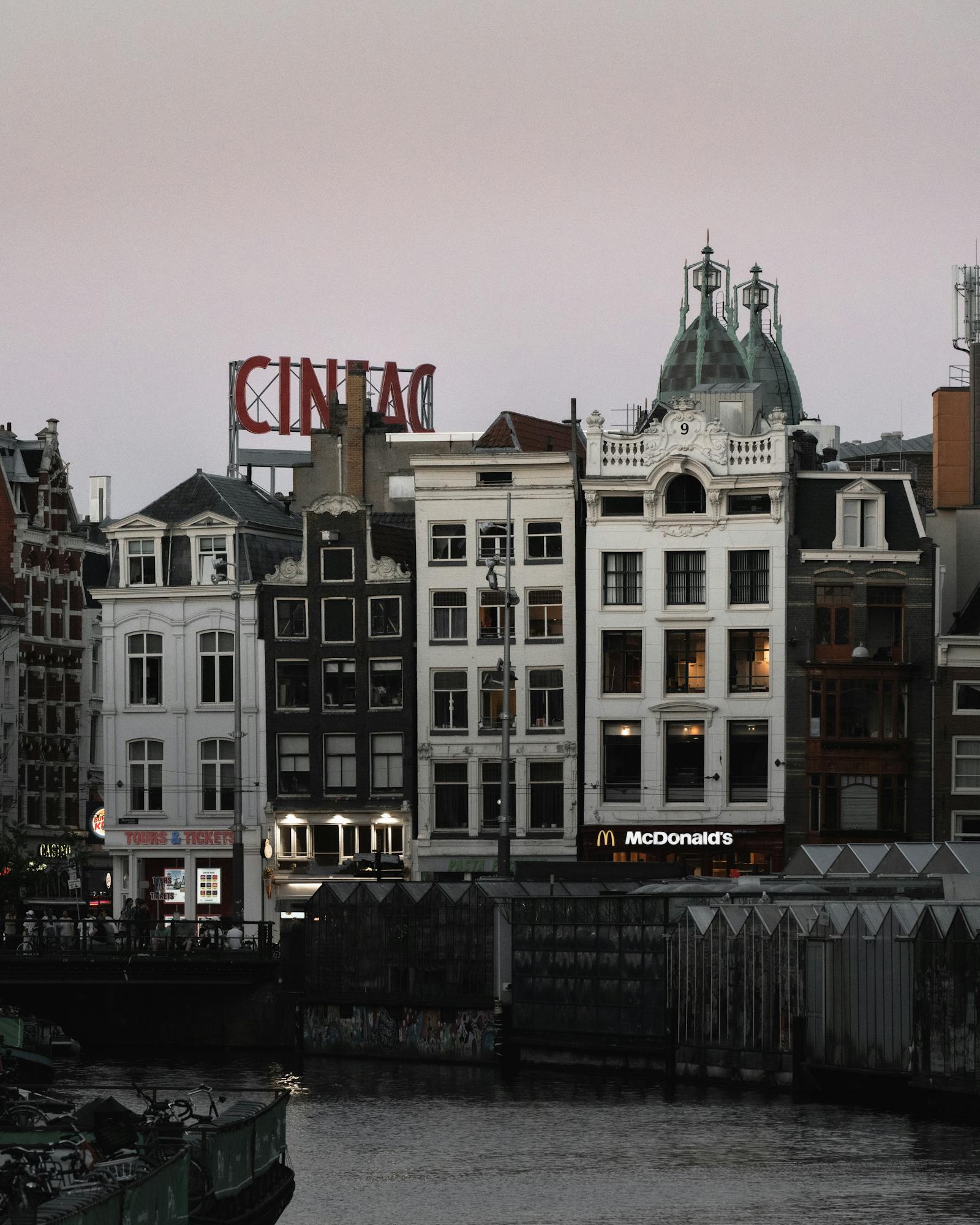 Charming Amsterdam canal and historic facades during twilight.